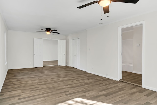 empty room featuring wood-type flooring and ceiling fan