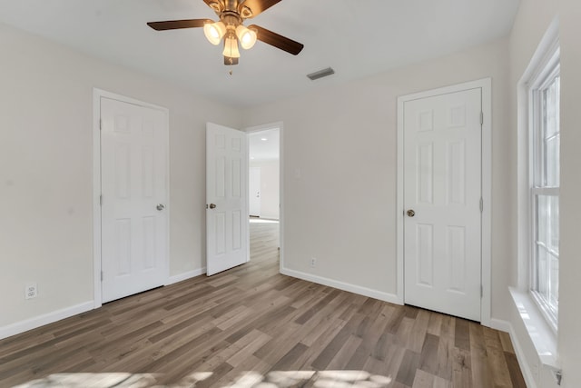 unfurnished bedroom with hardwood / wood-style floors and ceiling fan