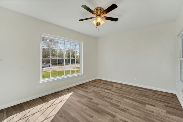 empty room with hardwood / wood-style floors and ceiling fan