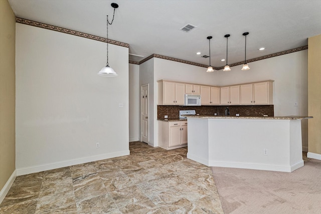 kitchen featuring baseboards, visible vents, white microwave, hanging light fixtures, and backsplash