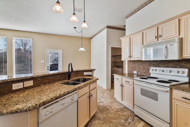 kitchen featuring tasteful backsplash, hanging light fixtures, a sink, dark stone counters, and white appliances