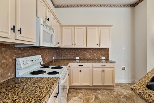 kitchen with tasteful backsplash, dark stone counters, and white appliances