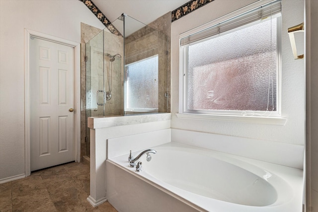 bathroom featuring a stall shower, plenty of natural light, and a bath