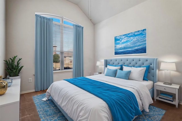 bedroom with lofted ceiling and multiple windows