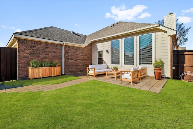 rear view of house featuring fence, an outdoor living space, a lawn, and a patio