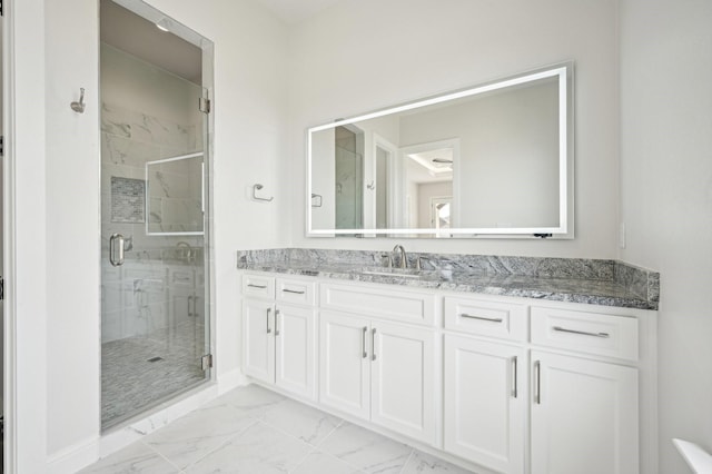 bathroom featuring vanity and a shower with shower door