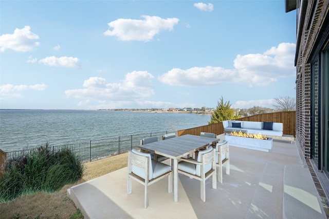 view of patio / terrace featuring a water view and an outdoor fire pit