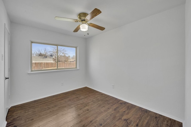 empty room with dark wood-type flooring and ceiling fan