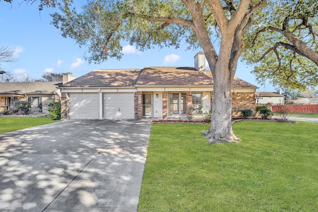 single story home featuring a garage and a front yard