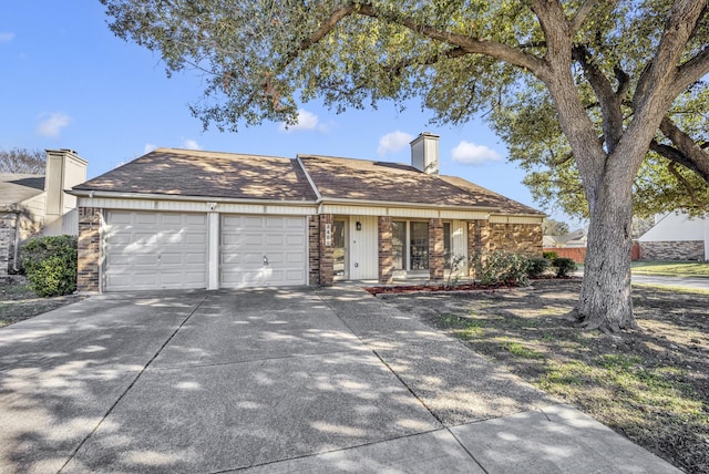 5400 Gregory Dr, Flower Mound, TX 75028 - view of front of house with a chimney, an attached garage, concrete driveway, and stone siding