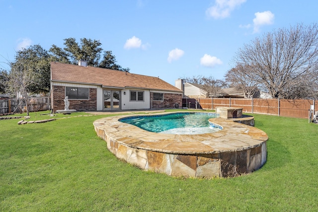 view of pool featuring french doors and a yard