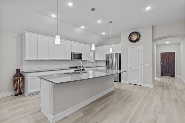 kitchen featuring decorative light fixtures, sink, white cabinetry, and stainless steel appliances