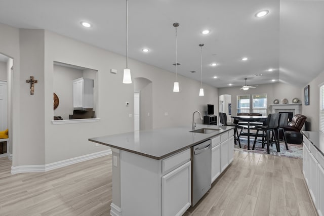 kitchen featuring white cabinets, ceiling fan, pendant lighting, a center island with sink, and dishwasher