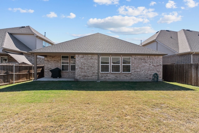 back of house featuring a patio area and a yard