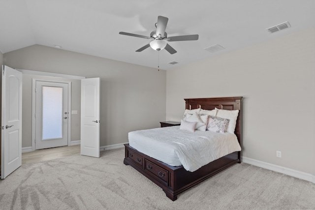 bedroom with ceiling fan, light carpet, and vaulted ceiling