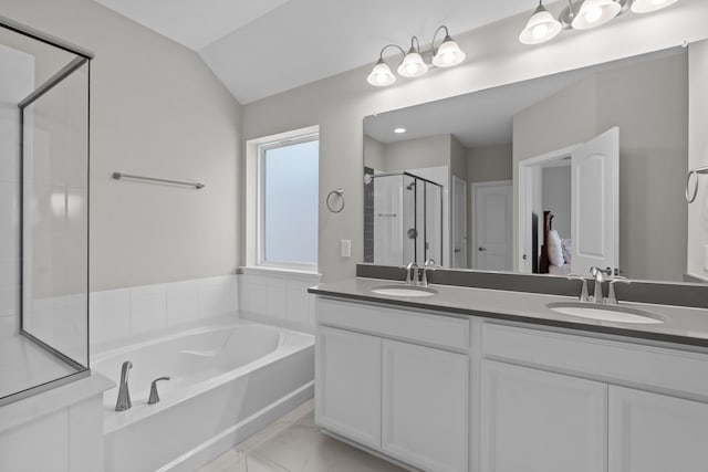 bathroom with vanity, separate shower and tub, and vaulted ceiling