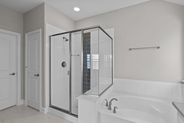 bathroom with separate shower and tub