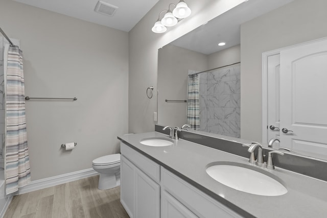 bathroom featuring walk in shower, toilet, vanity, and hardwood / wood-style flooring