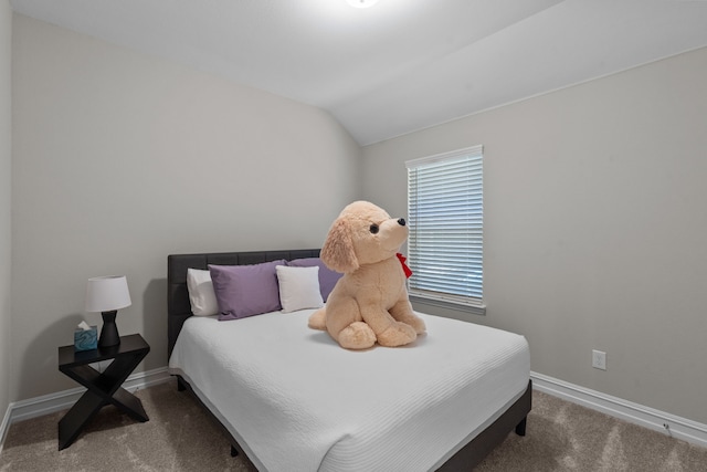 carpeted bedroom with lofted ceiling