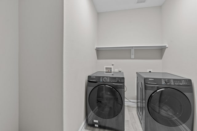 washroom featuring light hardwood / wood-style flooring and independent washer and dryer