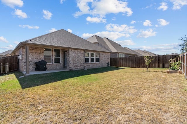 back of property with a patio area and a yard