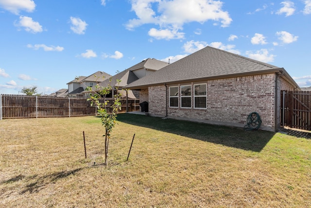 back of property with a lawn