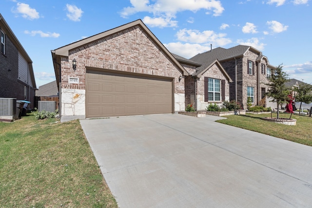 view of front of home featuring a front yard, a garage, and central air condition unit