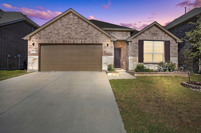 view of front of house featuring a garage and a yard