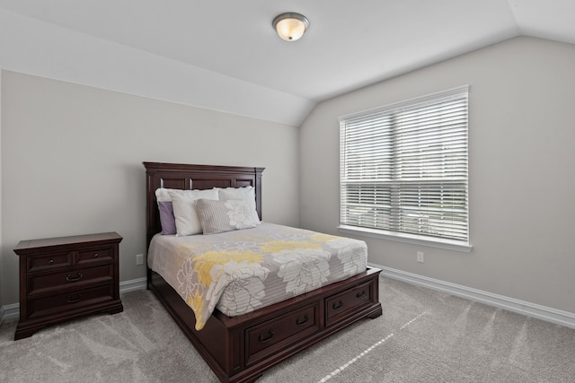 bedroom with light carpet and vaulted ceiling