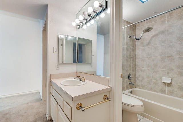 full bathroom with toilet, vanity, and tiled shower / bath