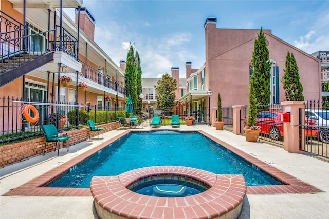 view of pool featuring a patio area and a hot tub