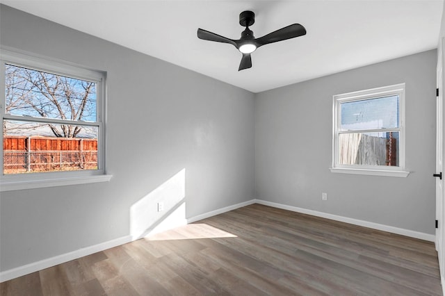 empty room with hardwood / wood-style flooring and ceiling fan