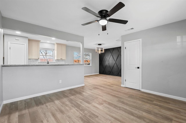 unfurnished living room featuring light wood finished floors, recessed lighting, visible vents, a ceiling fan, and baseboards