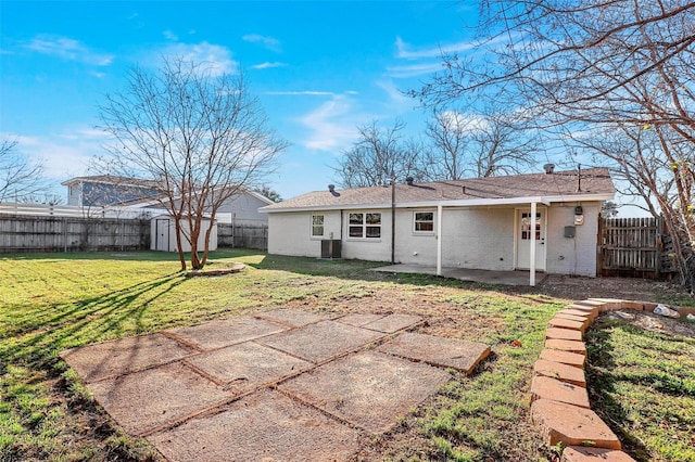 back of house featuring an outbuilding, a patio area, a fenced backyard, and a storage unit