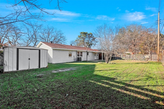 view of yard featuring central AC unit and a storage shed