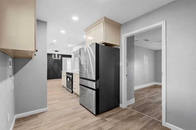 kitchen featuring stainless steel fridge and light hardwood / wood-style flooring