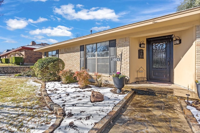 view of snow covered property entrance