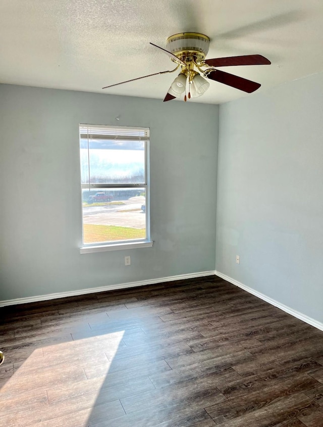 unfurnished room with dark hardwood / wood-style flooring and ceiling fan