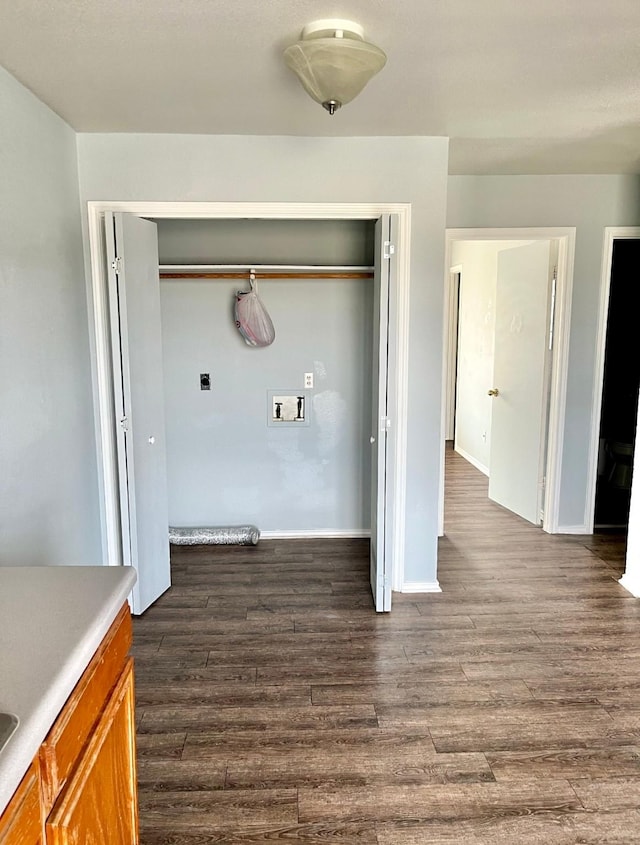 washroom with hookup for an electric dryer, hookup for a washing machine, and dark hardwood / wood-style floors