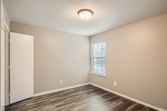 spare room with dark hardwood / wood-style floors