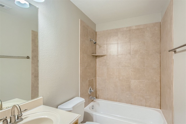 full bathroom with vanity, toilet, and tiled shower / bath