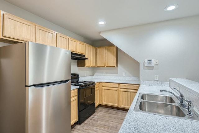 kitchen with light brown cabinetry, sink, stainless steel refrigerator, black range with electric cooktop, and light hardwood / wood-style floors