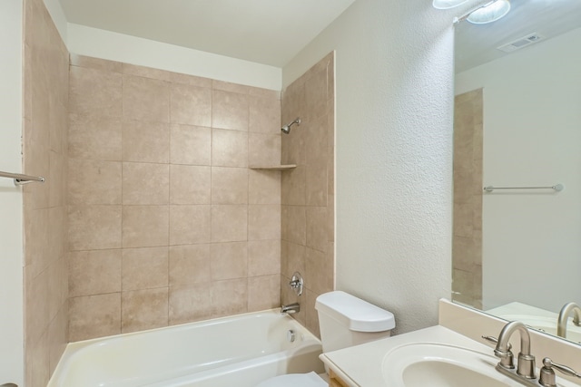 full bathroom featuring vanity, toilet, and tiled shower / bath combo