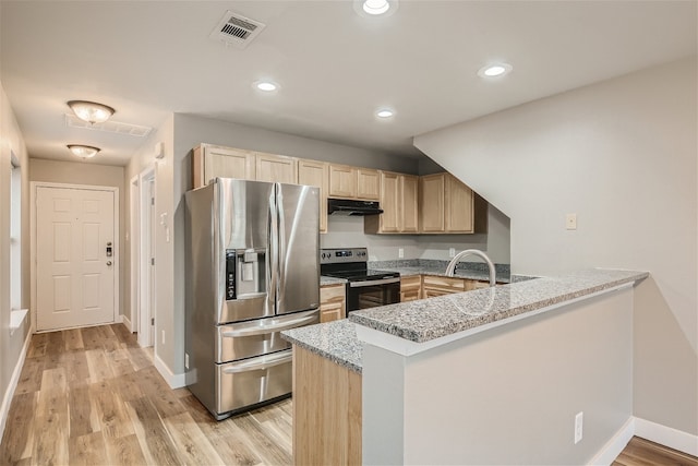 kitchen with appliances with stainless steel finishes, light brown cabinets, light stone counters, and kitchen peninsula