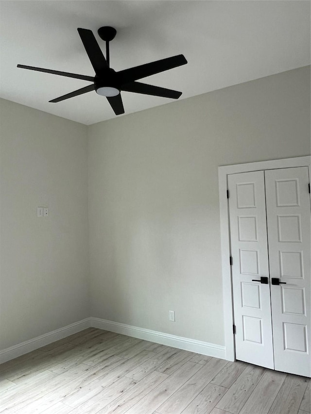 empty room with light hardwood / wood-style floors and ceiling fan