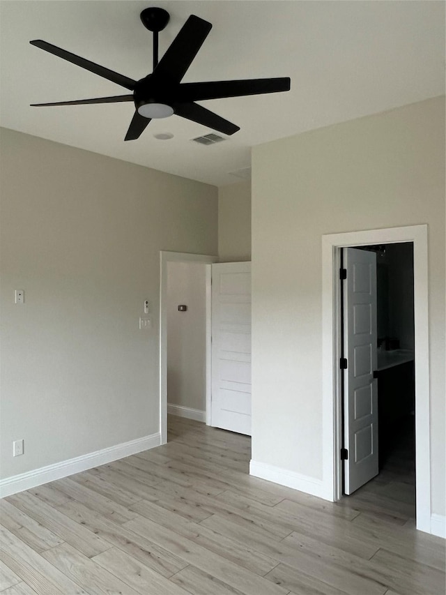 empty room with light hardwood / wood-style floors and ceiling fan