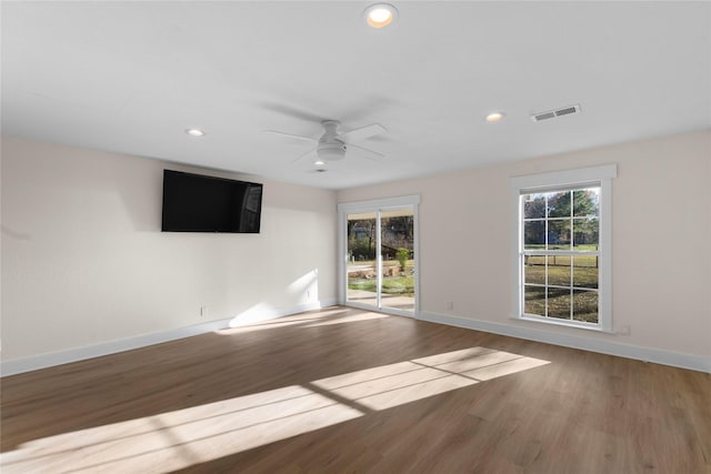 unfurnished room with ceiling fan and wood-type flooring