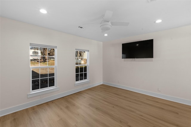 empty room with light hardwood / wood-style floors and ceiling fan