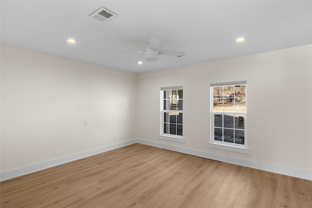 spare room featuring light hardwood / wood-style floors and ceiling fan