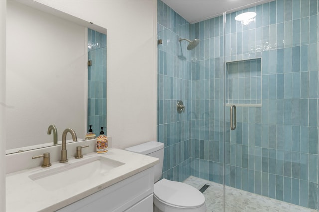 bathroom with vanity, an enclosed shower, and toilet